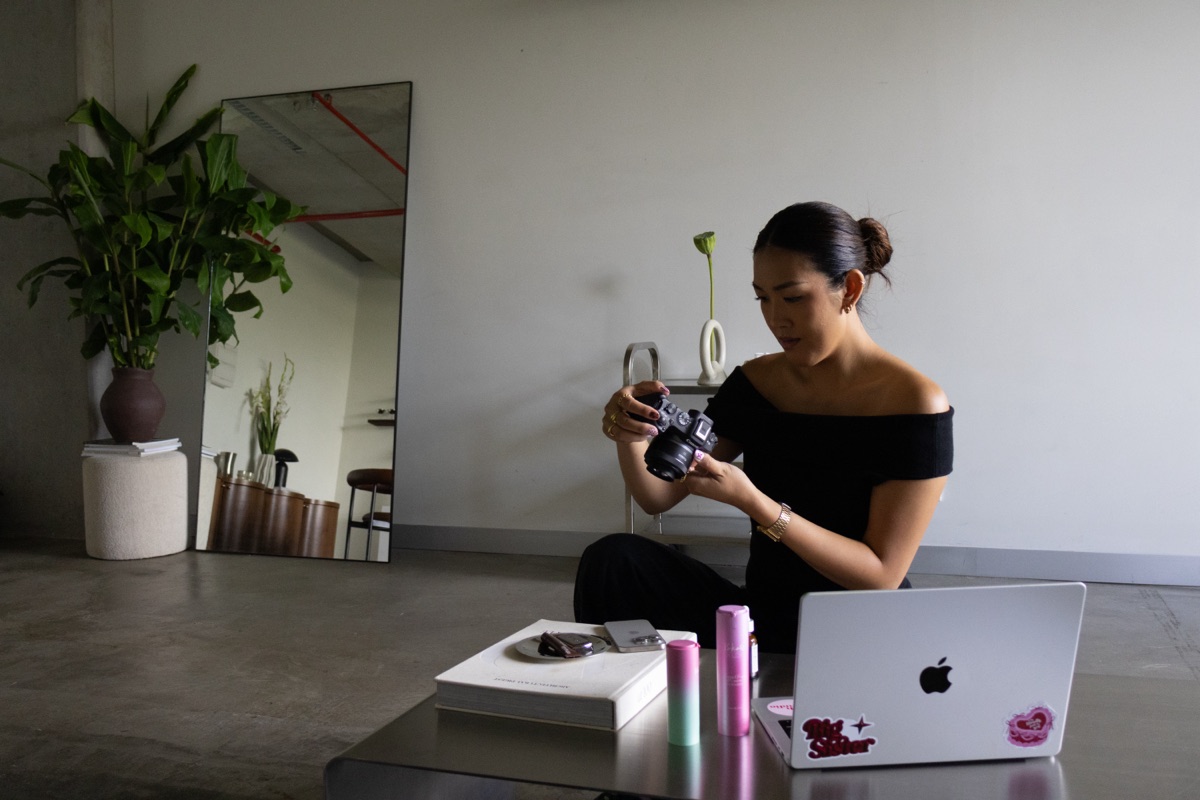 Sarah reviewing footage on her camera in the studio